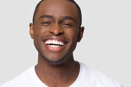 general dentistry man smiling white backdrop