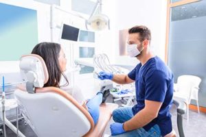 woman in dentist chair learning about lovett dental meyerland plaza from dental hygienist