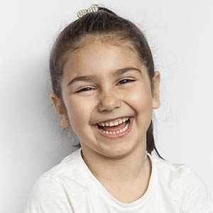 young girl laughing after family dentistry services in tx