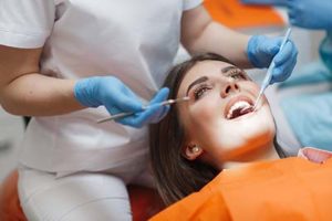 woman laying back getting the best dental implants in Meyersland plaza,TX