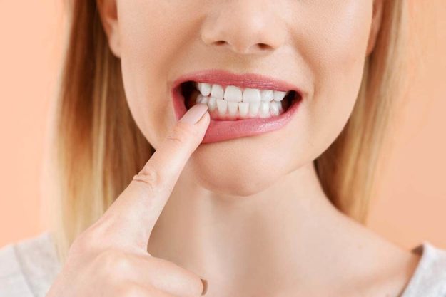 loose adult tooth woman experiencing a loose adult tooth