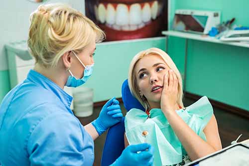 emergency dental services (2) woman seeking emergency dental services from her dentist