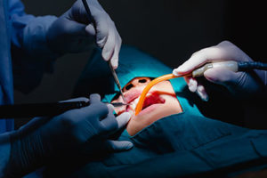 oral surgery on dental patient