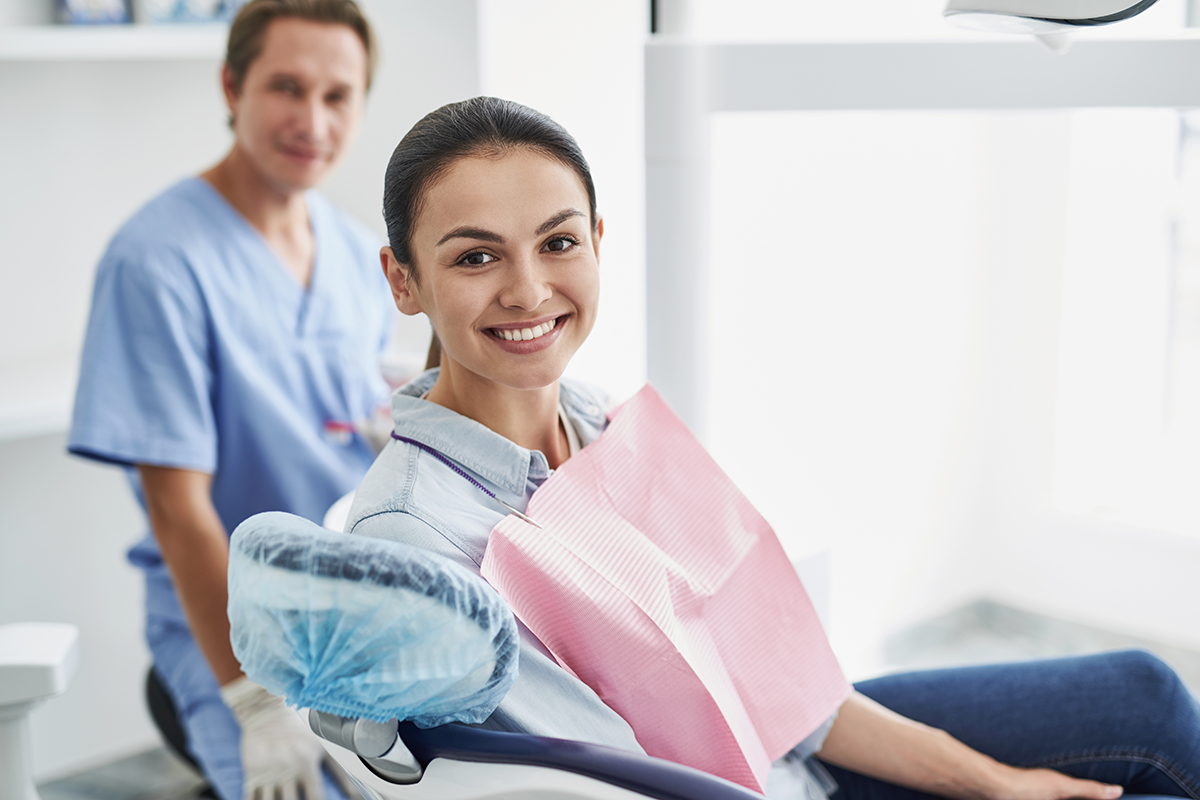 saturday dental appointments woman smiling in dentist chair after making a Saturday Dental Appointments