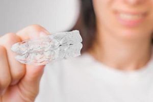 woman shows off her clear aligner trays 