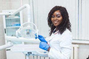 doctor prepares to give a dental exam 