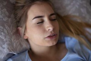 woman struggles with teeth grinding